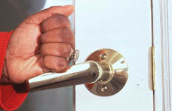 closed fist opening a door lever