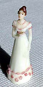 Lady of 1815 in white empire-waisted gown with pink roses.